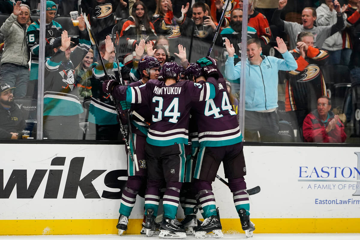 Anaheim Ducks surround center Sam Carrick after his goal during the third period of an NHL hock ...