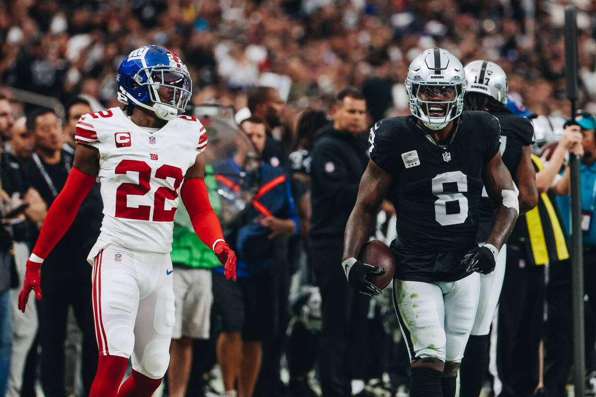 Raiders running back Josh Jacobs (8) celebrates a run during the first half of a game against t ...