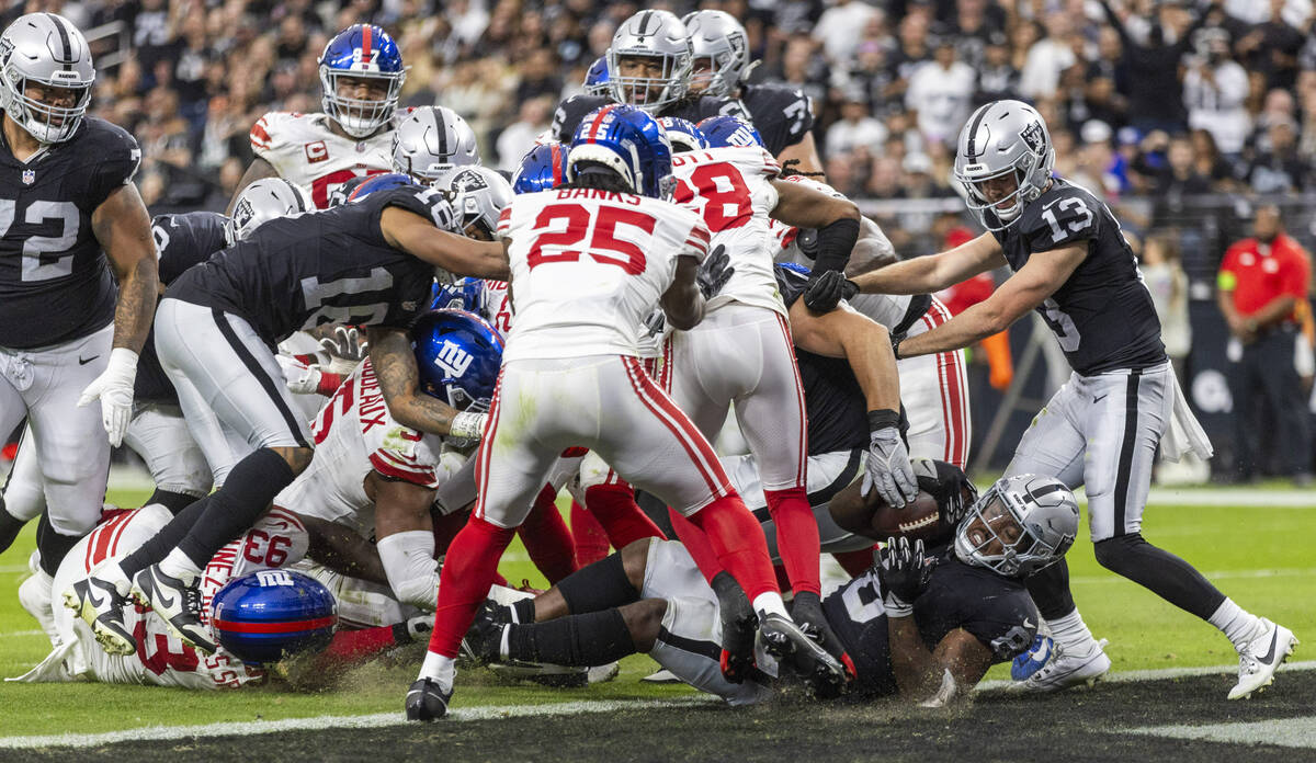 Vegas Raiders running back Josh Jacobs (8) scores against the New York Giants during the first ...