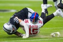 Vegas Raiders defensive end Maxx Crosby (98) takes down New York Giants quarterback Tommy DeVit ...