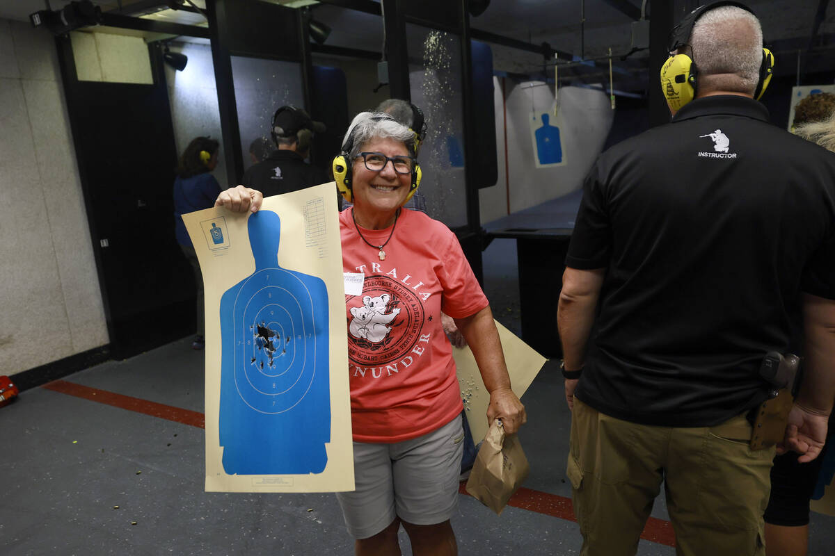 Sandi Lazar, who is Jewish, shows off her target during an introduction to handguns course at t ...