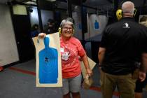 Sandi Lazar, who is Jewish, shows off her target during an introduction to handguns course at t ...