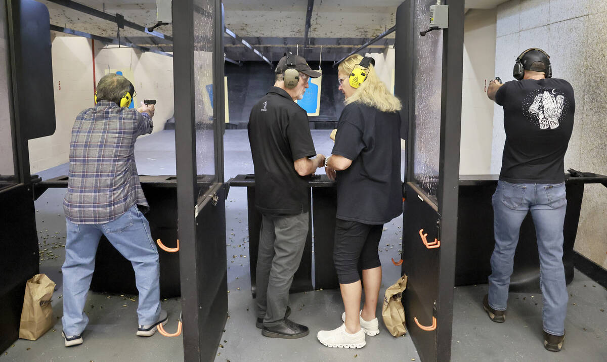 Firearms instructor Bob Pruitt talks with student Jackie Rubin, a former orthodox Jew who conve ...