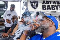 Fans enjoy cigars in the tailgating area before the start of the Raiders against the New York G ...