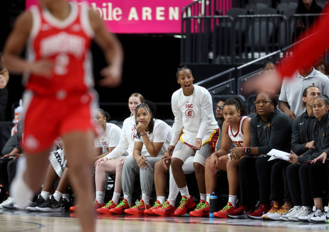 Former Spring Valley High basketball star Aaliyah Gayles, standing, cheers with her USC teammat ...