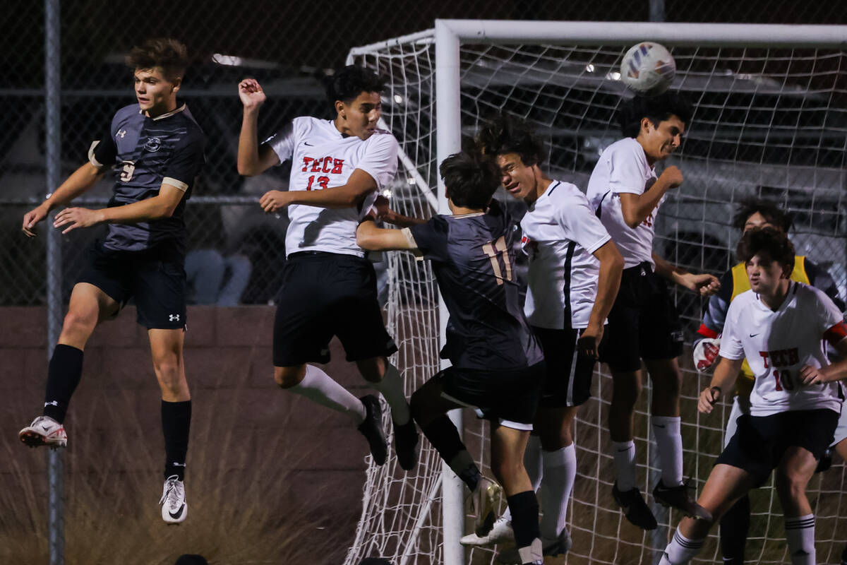 Faith Lutheran and Southeast Career Technical Academy players all jump to head a corner kick du ...