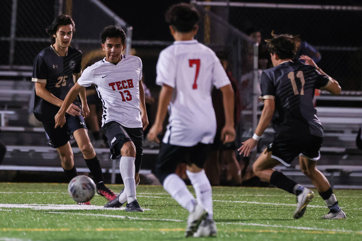 Southeast Career Technical Academy’s Omar Ibarra (13) kicks the ball away from Faith Lut ...