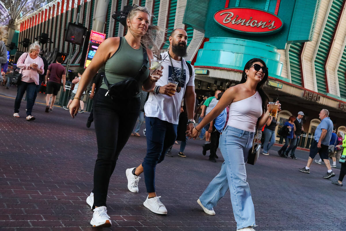 Tourists battle through the wind along Fremont Street on Monday, Nov. 6, 2023 in Las Vegas. (Da ...