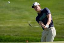 Maverick McNealy chips to the third green during a practice round at The Players Championship g ...