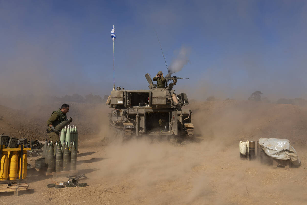 An Israeli mobile artillery unit fires a shell from southern Israel towards the Gaza Strip, in ...