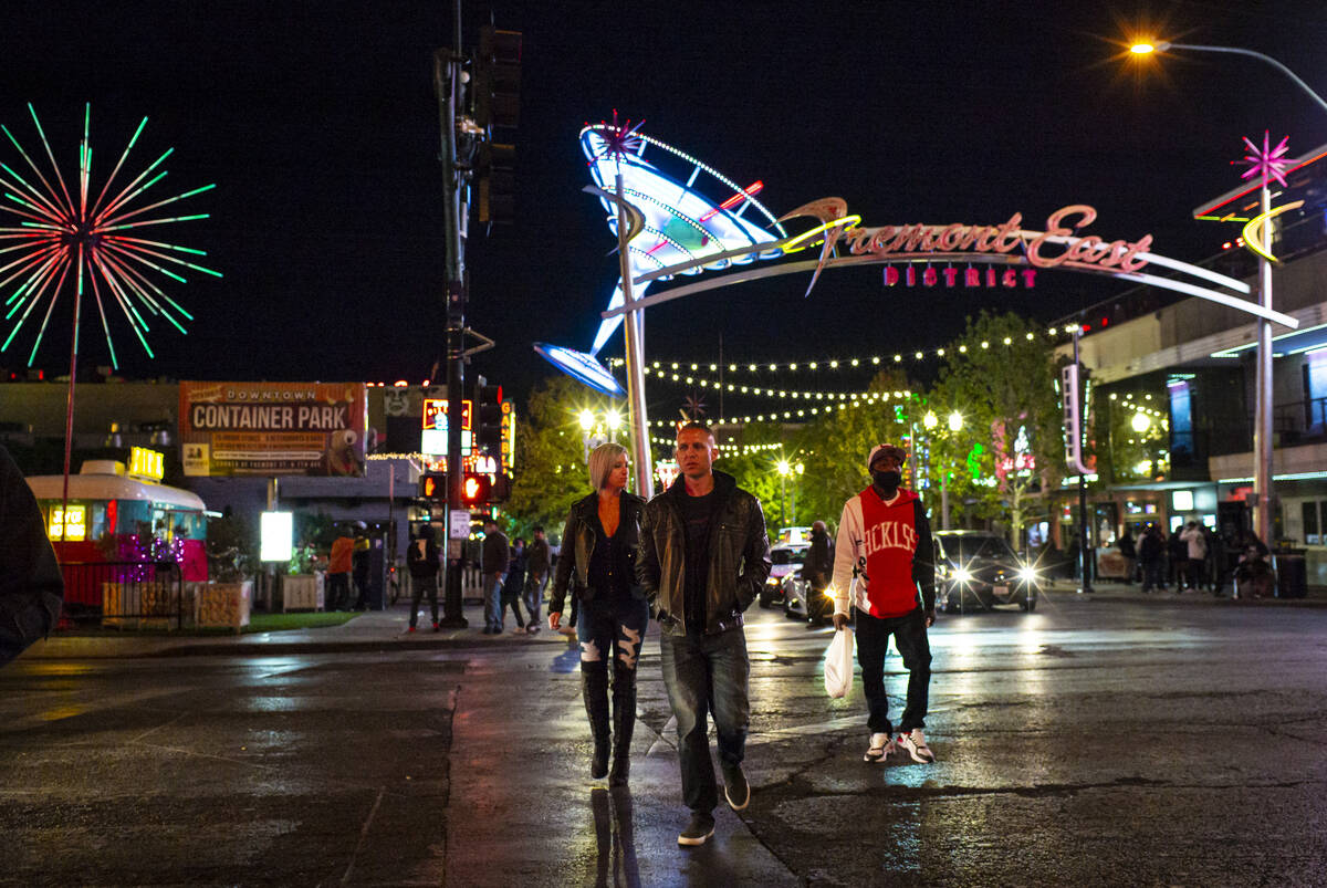 People walk around Fremont East in downtown Las Vegas on Saturday, Nov. 21, 2020. (Chase Steven ...