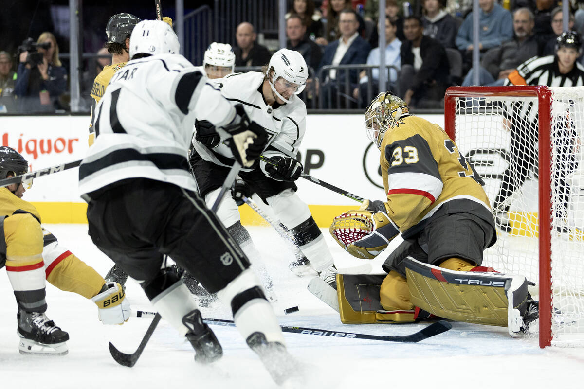 Golden Knights goaltender Adin Hill (33) saves the puck against Kings center Adrian Kempe (9) d ...