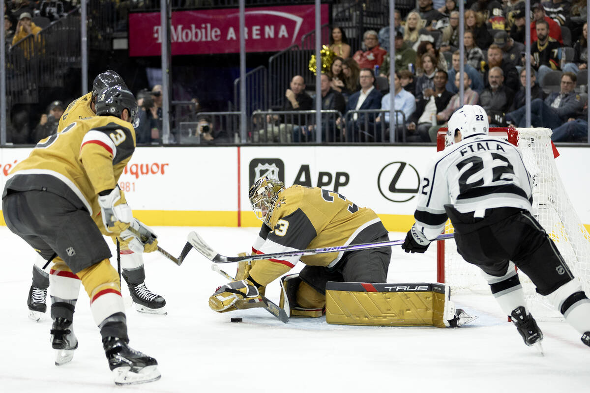 Golden Knights goaltender Adin Hill (33) saves the puck after Kings left wing Kevin Fiala (22) ...