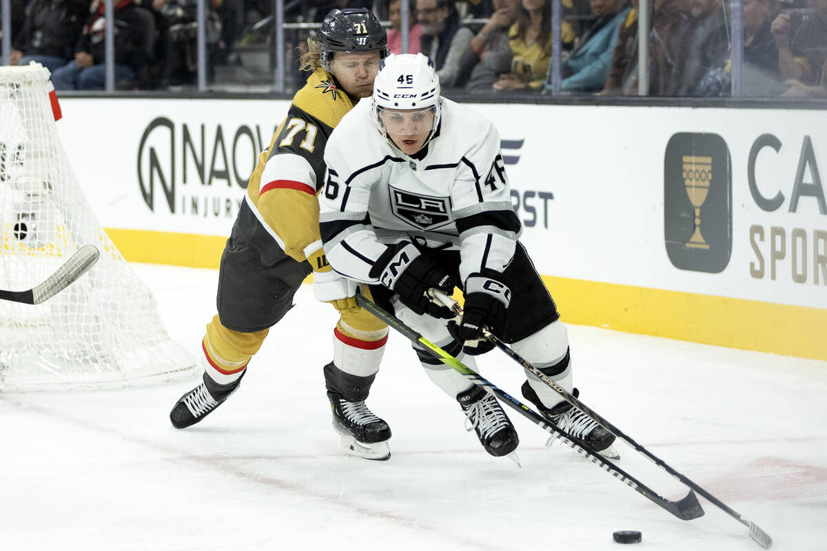 Golden Knights center William Karlsson (71) struggles for the puck against Kings center Blake L ...