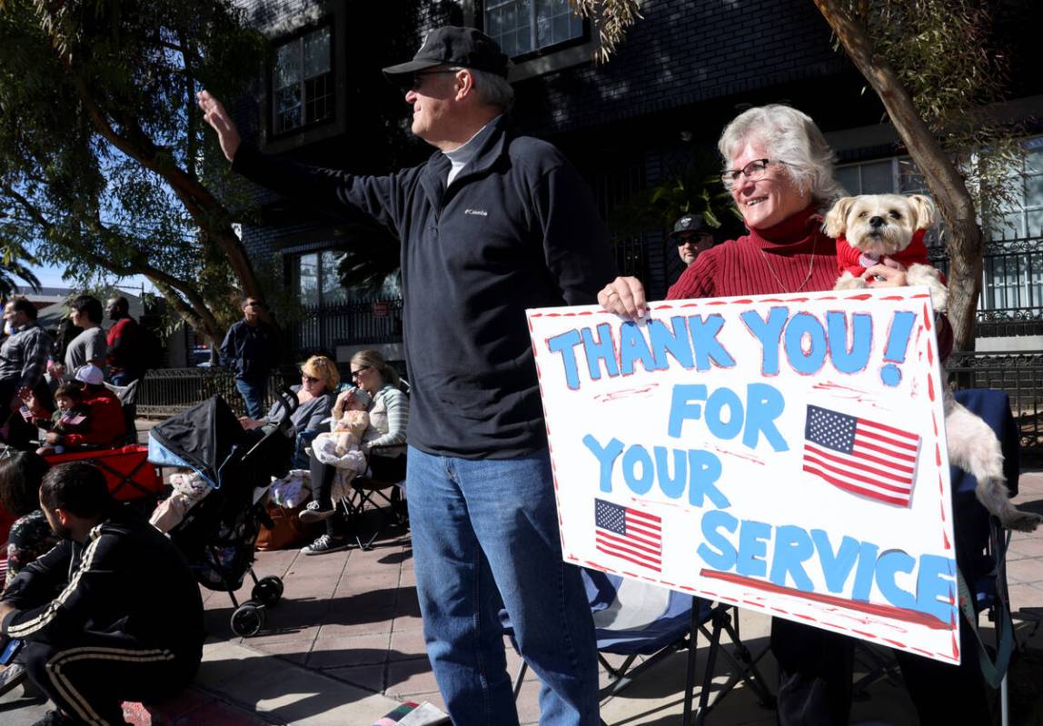 Sue Bartling, her dog Libby Lulu and husband Tom watch the Veterans Day parade on Fourth Street ...