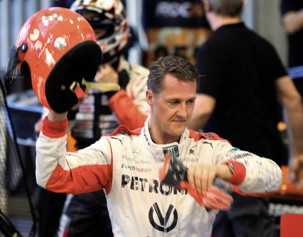 Michael Schumacher of Germany holds a helmet after a test drive prior to the Race Of Champions ...