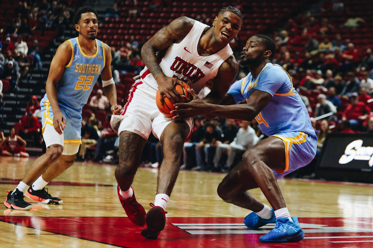 UNLV guard Luis Rodriguez (15) fights to keep the ball in his possession during a game against ...