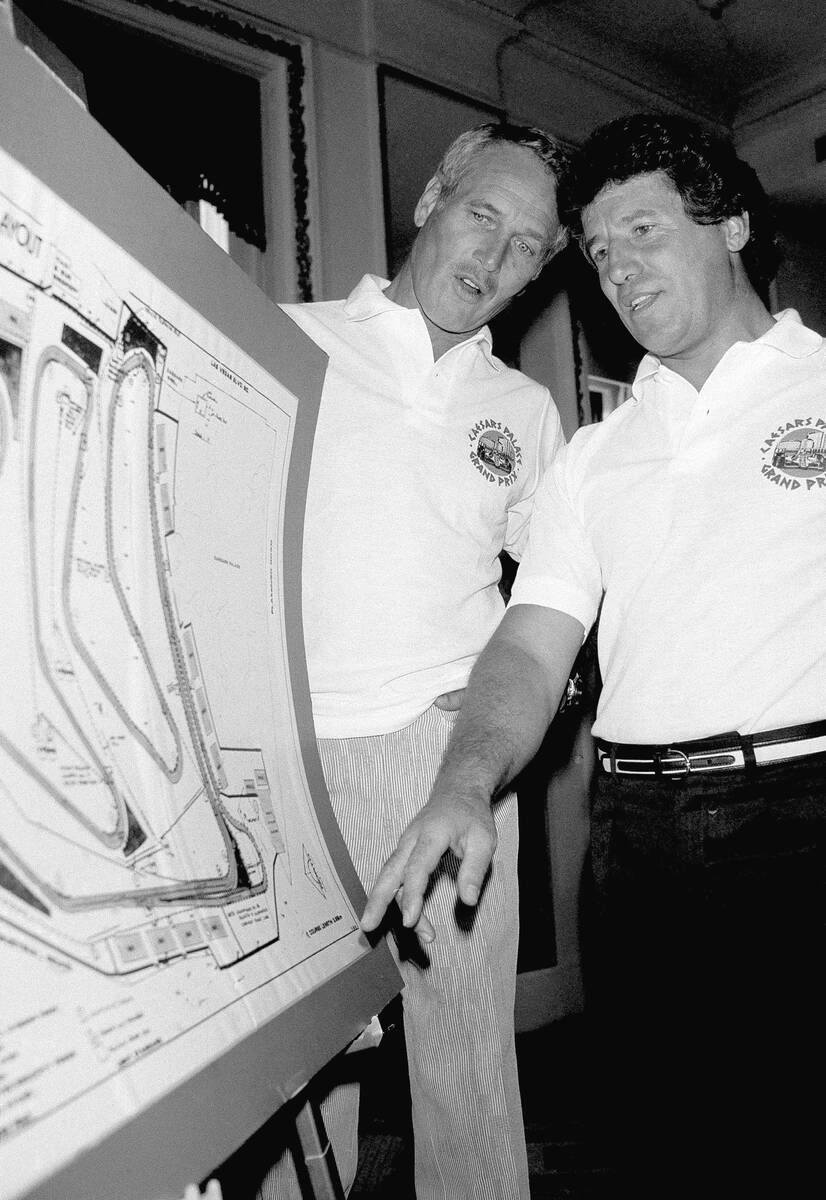 Actor-auto racer Paul Newman, left, and racer Mario Andretti inspect a map in New York, Aug. 31 ...