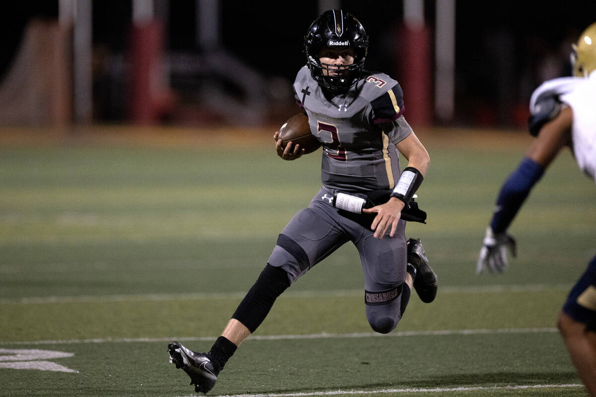 Faith Lutheran quarterback Garyt Odom (3) keeps the ball during the second half of a high schoo ...