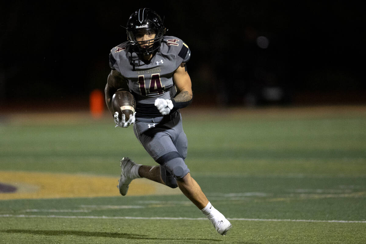 Faith Lutheran running back Cale Breslin (14) runs the ball during the first half of a high sch ...