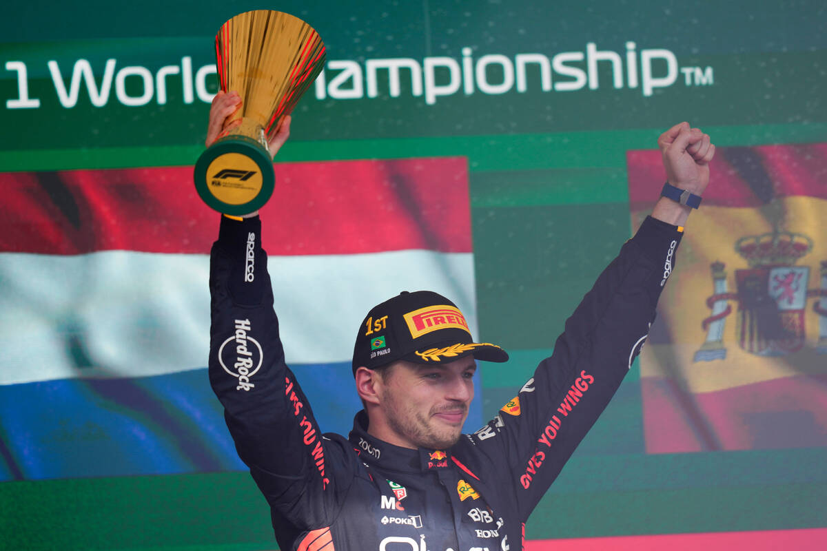 Red Bull driver Max Verstappen of the Netherlands celebrates at the podium after winning the Br ...