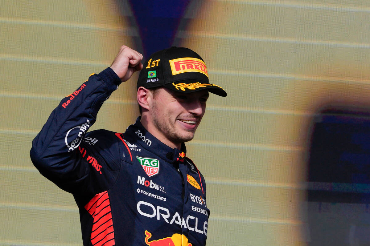 Red Bull driver Max Verstappen of the Netherlands celebrates his first place on the podium at t ...