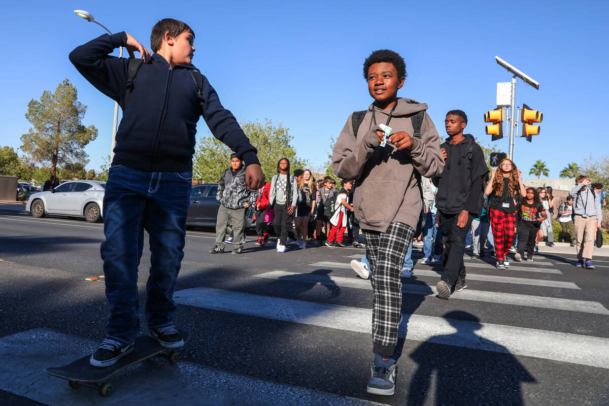 Middle School children cross Valle Verde Drive as they leave Greenspun Junior High School on Th ...