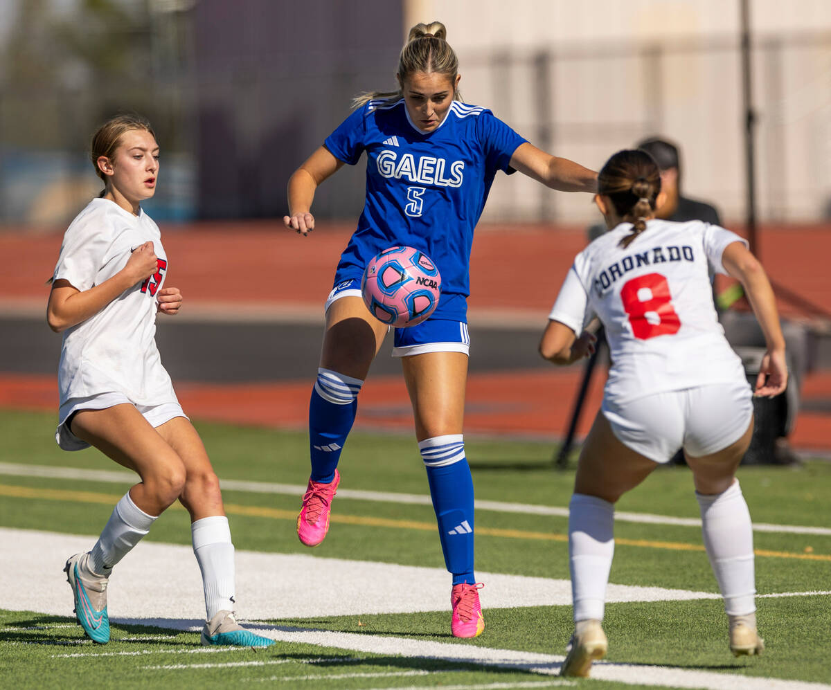 Bishop Gorman defender Aubrey Swanis (5) takes control of the ball between Coronado defender Jo ...