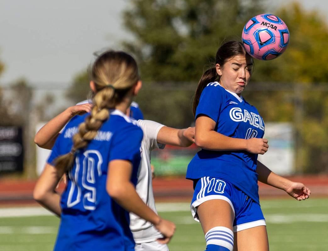 Bishop Gorman defender Stephanie Hackett (10) heads the ball over Coronado during the first ha ...