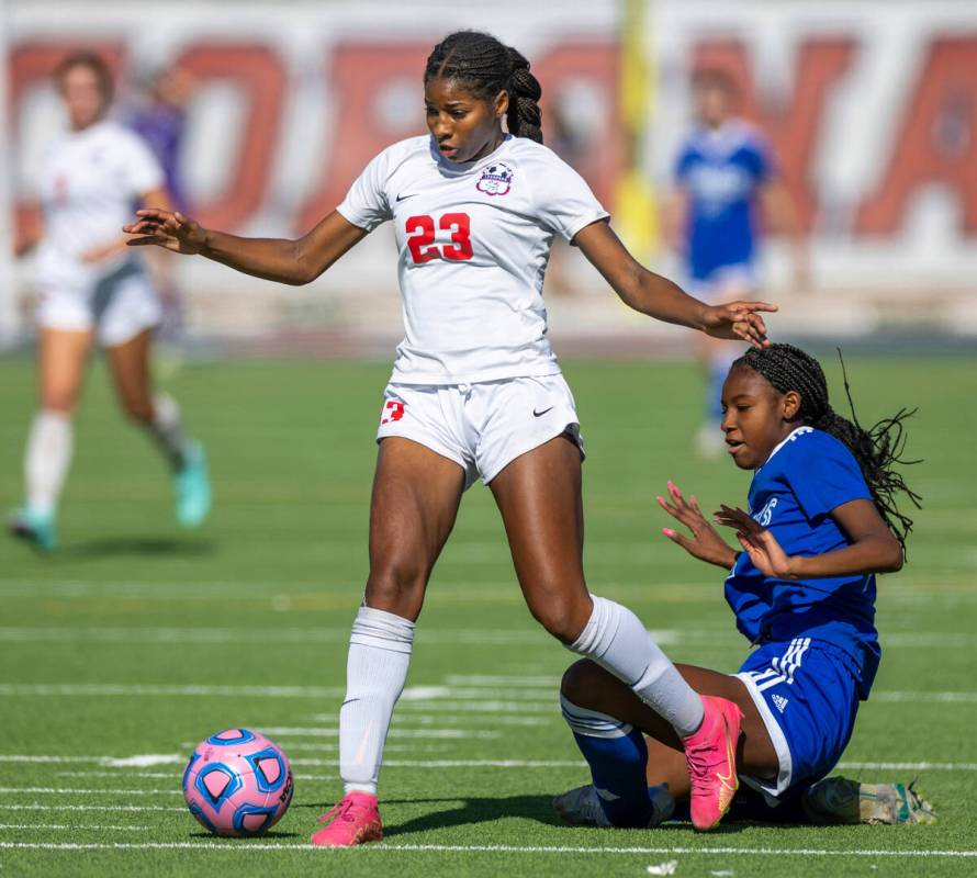 Coronado midfielder Sierah McCallum (23) survives a collision with Bishop Gorman midfielder Ami ...