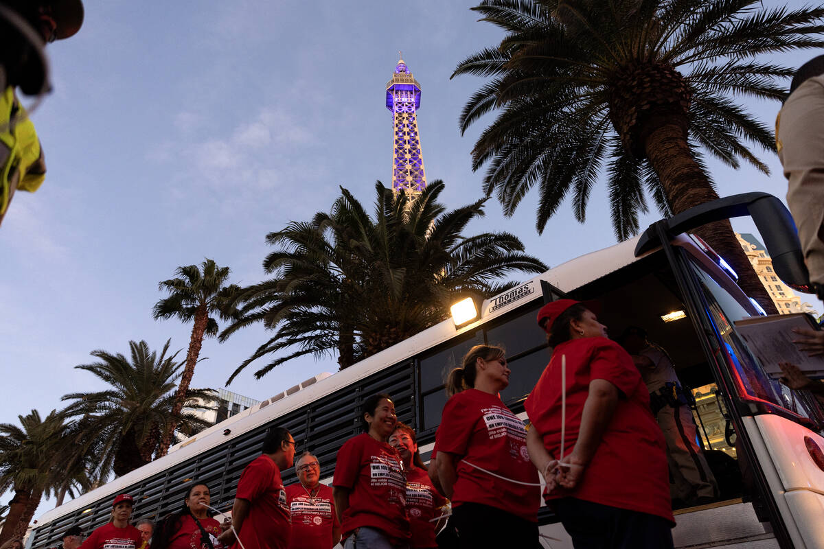 Culinary Local 226 members are loaded into transport busses after being arrested for blocking t ...