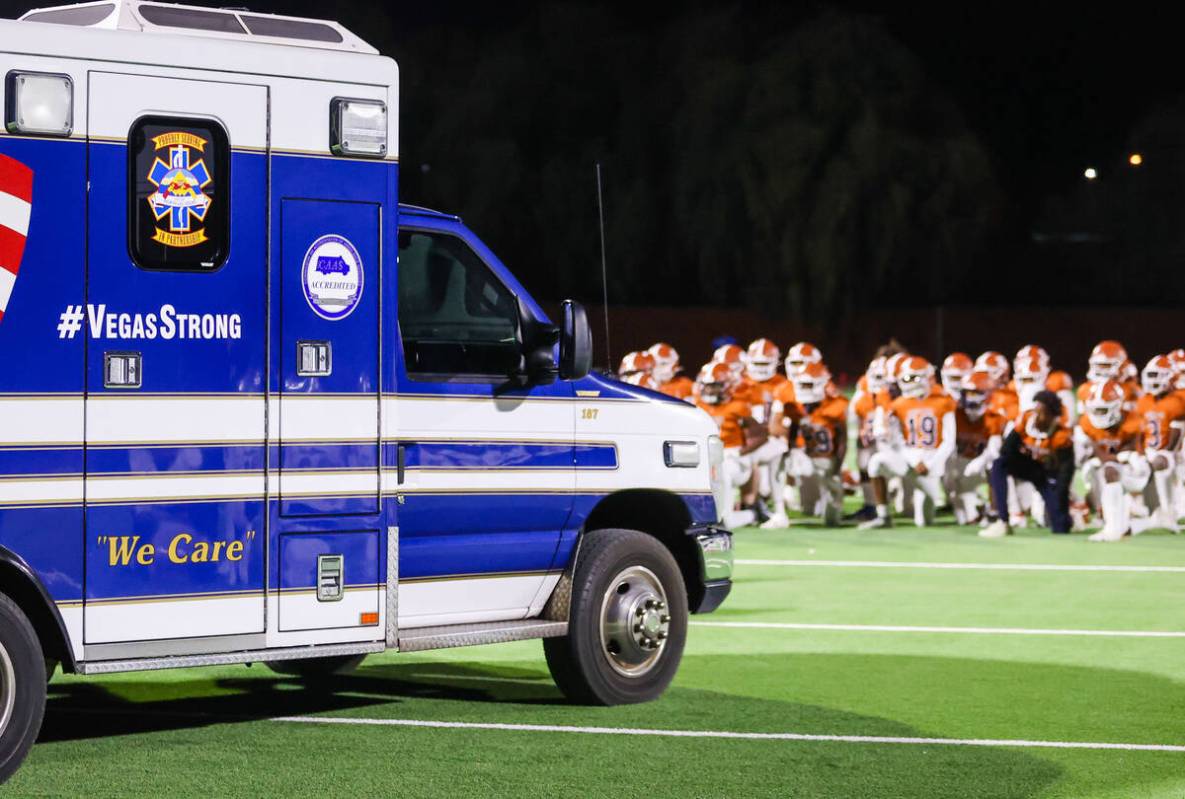 Legacy players take a knee as they await their teammate, Dominic Oliver (1), to be helped by pa ...