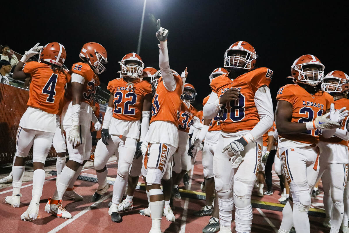 Legacy High School football players celebrate winning the Class 5A Division III Southern League ...