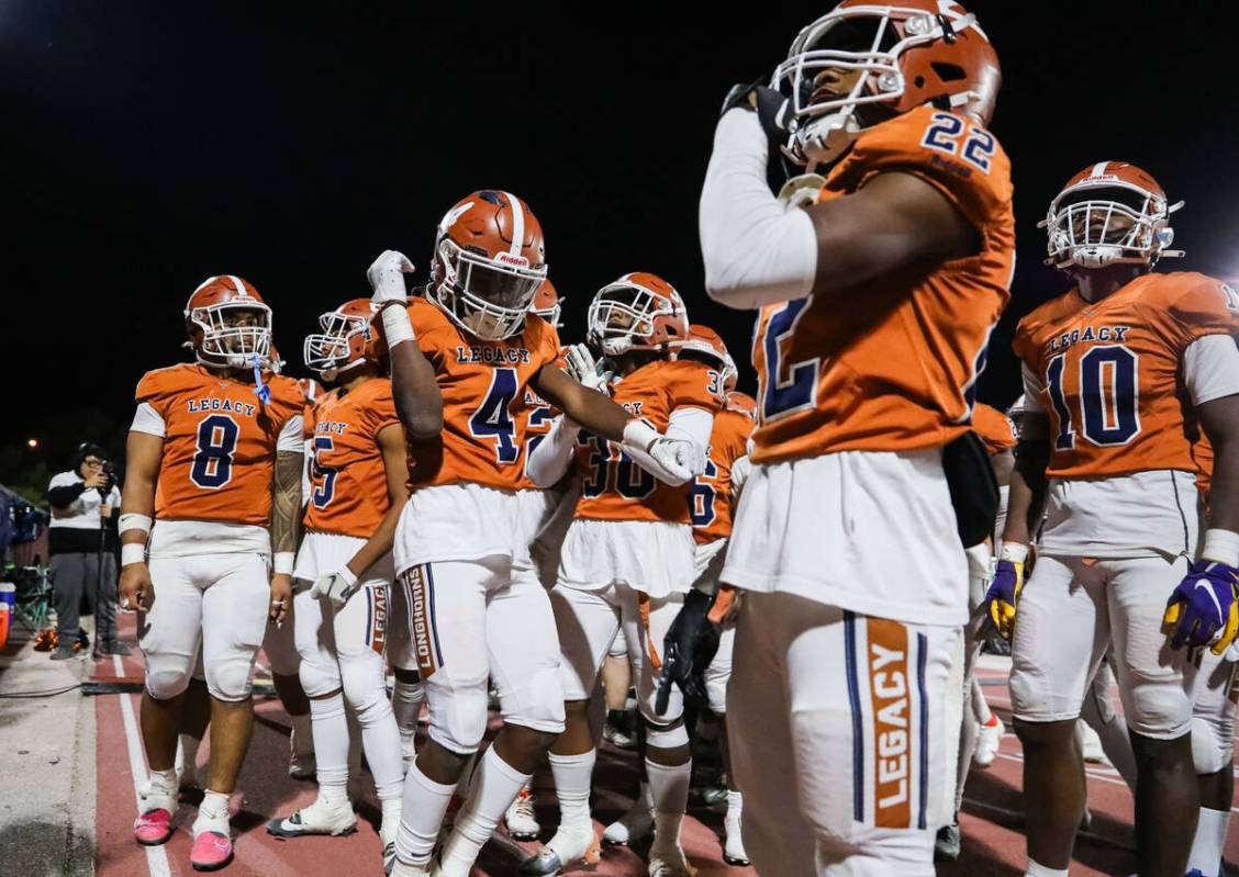 Legacy High School football players celebrate winning the Class 5A Division III Southern League ...