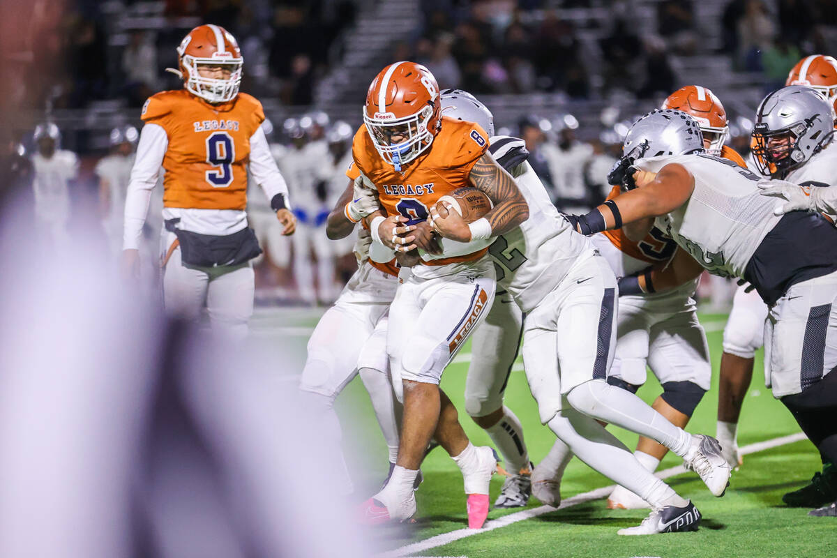 Legacy’s Phoenix Jennings (8) runs past Palo Verde defensive players during the Class 5A ...