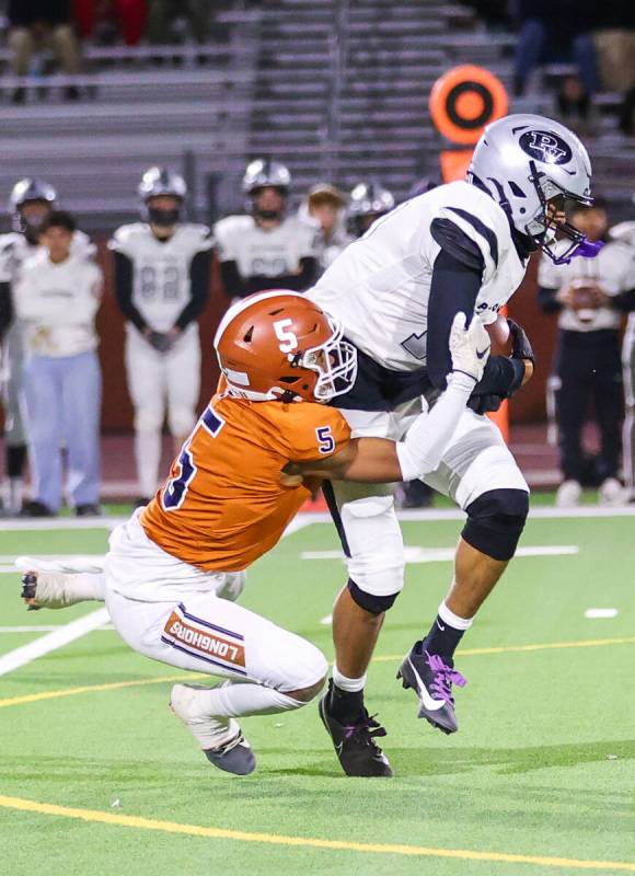 Legacy’s Zaione Henderson (5) attempts to tackle a Palo Verde player who is carrying the ...