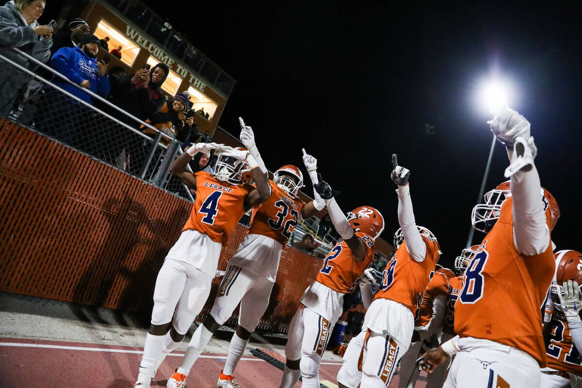 Legacy High School football players celebrate winning the Class 5A Division III Southern League ...