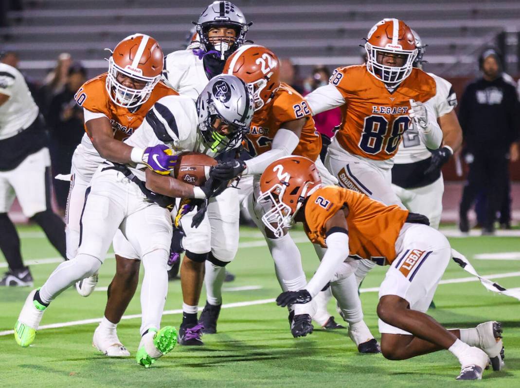 Legacy defensive players take down a Palo Verde running back during the Class 5A Division III S ...