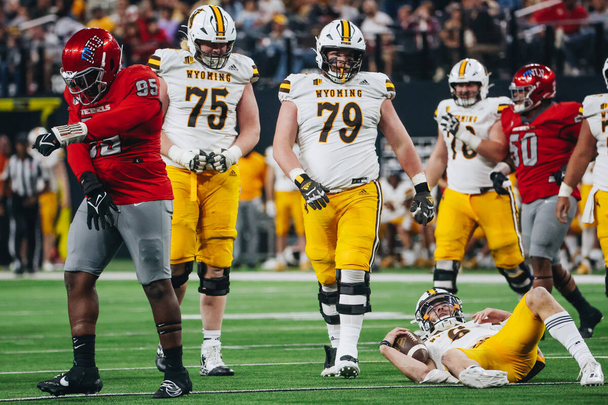 UNLV defensive lineman Alexander Whitmore (95) celebrates taking down Wyoming quarterback Andre ...