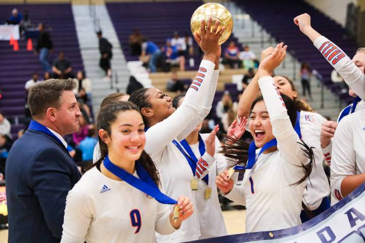 Bishop Gorman celebrates winning the class 5A girls volleyball state title match against Corona ...