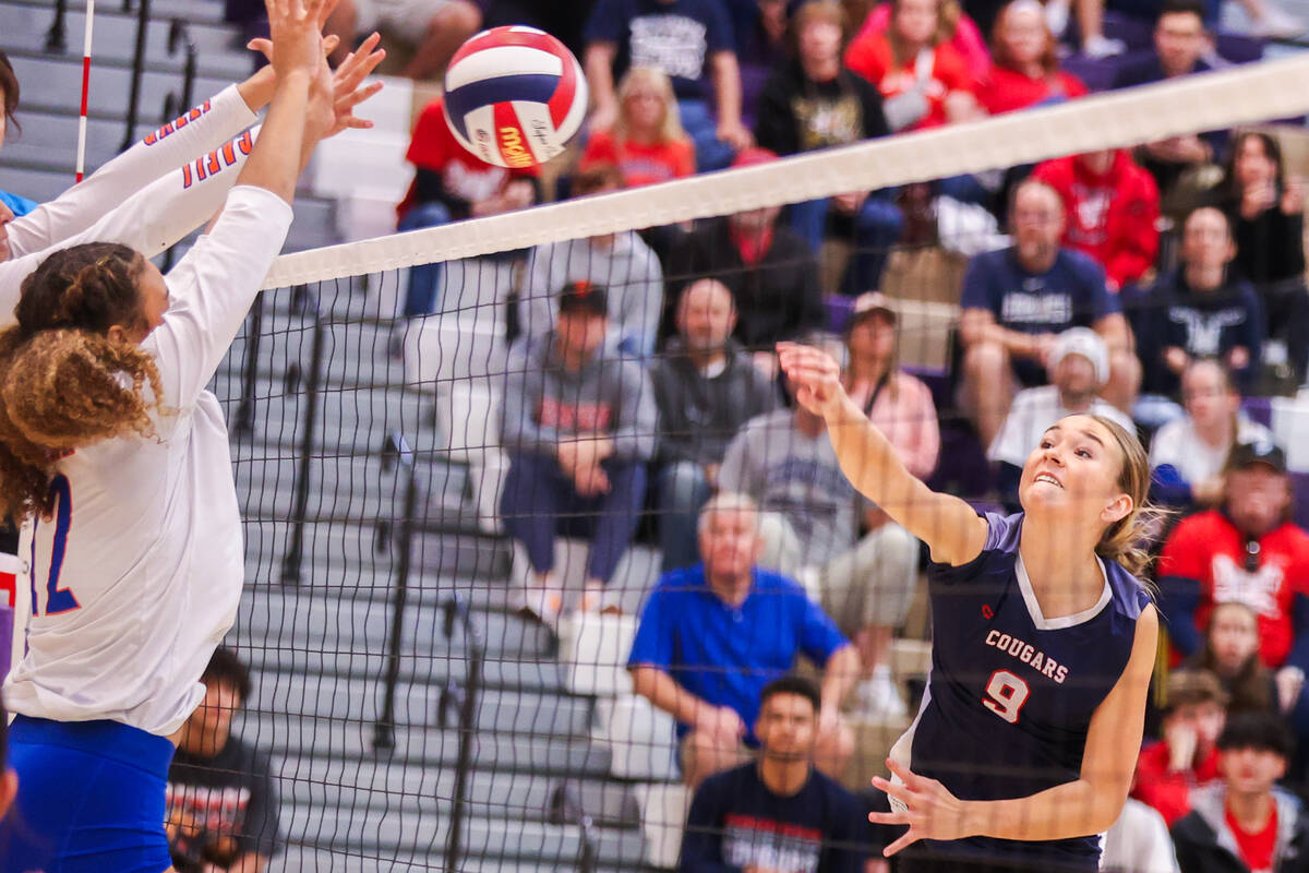 Coronado’s Rachel Purser (9) spikes the ball while Bishop Gorman players attempt to bloc ...