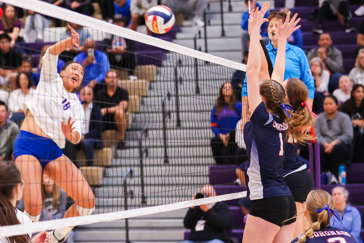 Bishop Gorman’s Leilia Toailoa (18) spikes the ball while Coronado players attempt to bl ...