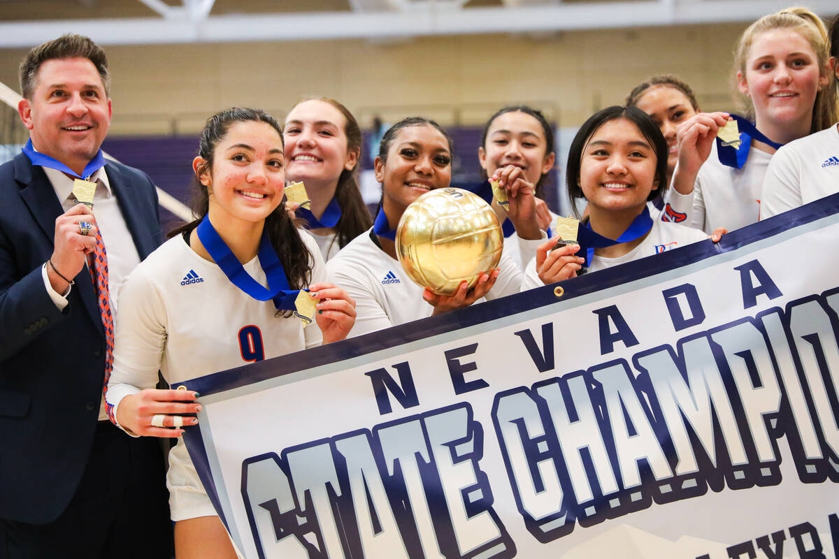 Bishop Gorman celebrates winning the class 5A girls volleyball state title match against Corona ...