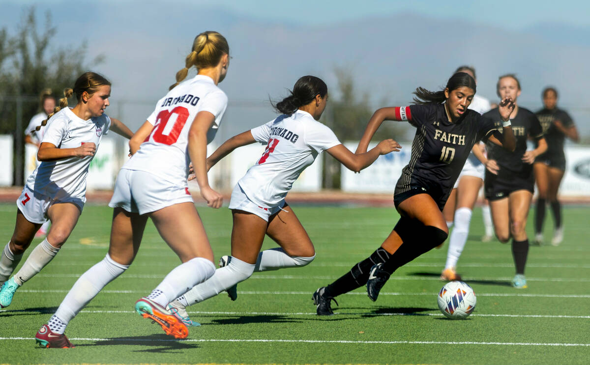 Faith Lutheran midfielder Andrea Leyva (10) drives with the ball against Coronado defender Tie ...