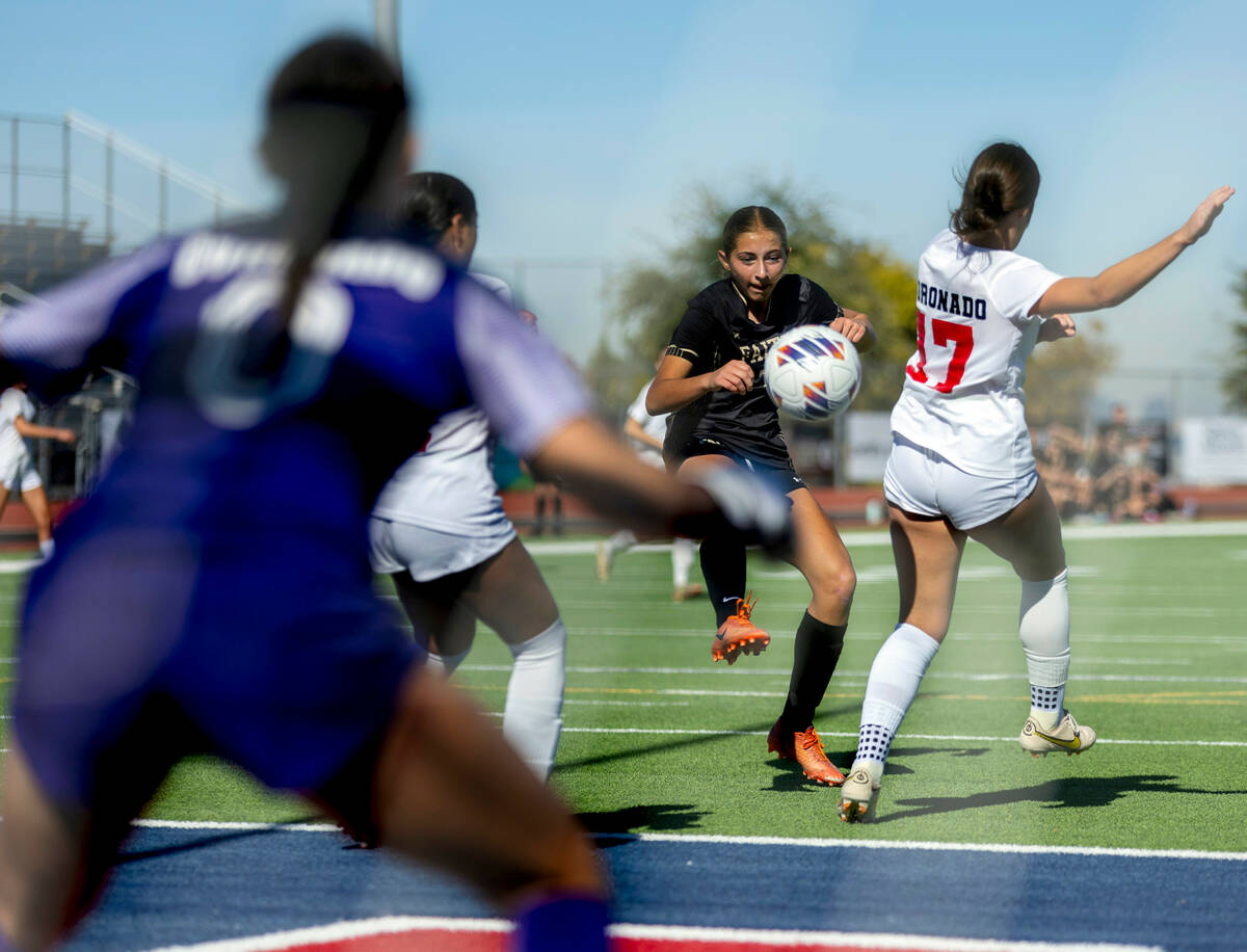 Faith Lutheran midfielder Julia Vancura (7) takes a shot on goal past Coronado defender Ella Sc ...