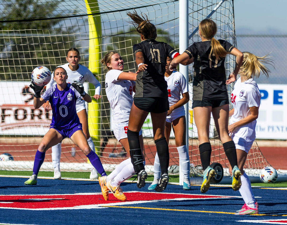 Coronado goalkeeper Megan Kingman (0) looks to grab a ball headed for a score attempt by Faith ...