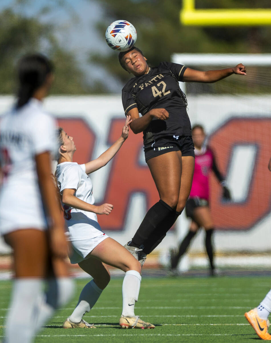 Faith Lutheran midfielder Jailynn Henry (42) heads the ball against the Coronado defense during ...