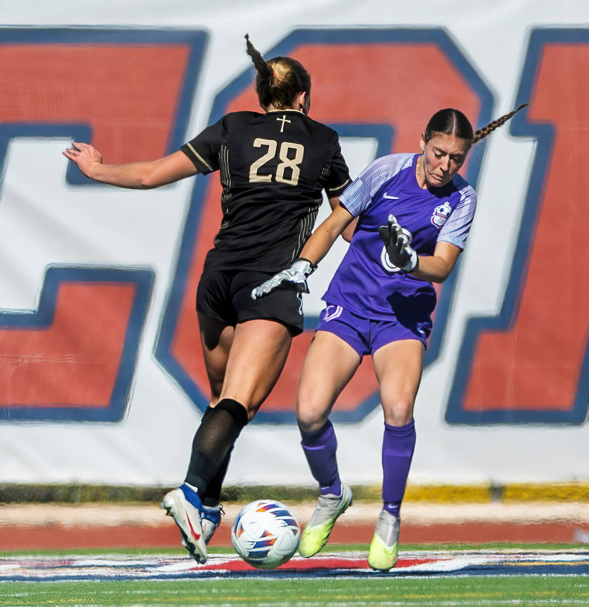 Coronado goalkeeper Megan Kingman (0) makes a save as Faith Lutheran forward Allison Rabe (28) ...