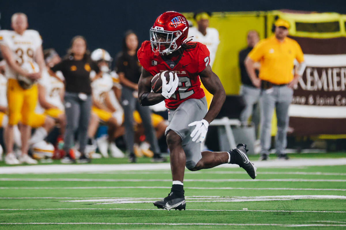 UNLV running back Jai'Den Thomas (22) runs the ball down the field during a game against Wyomin ...