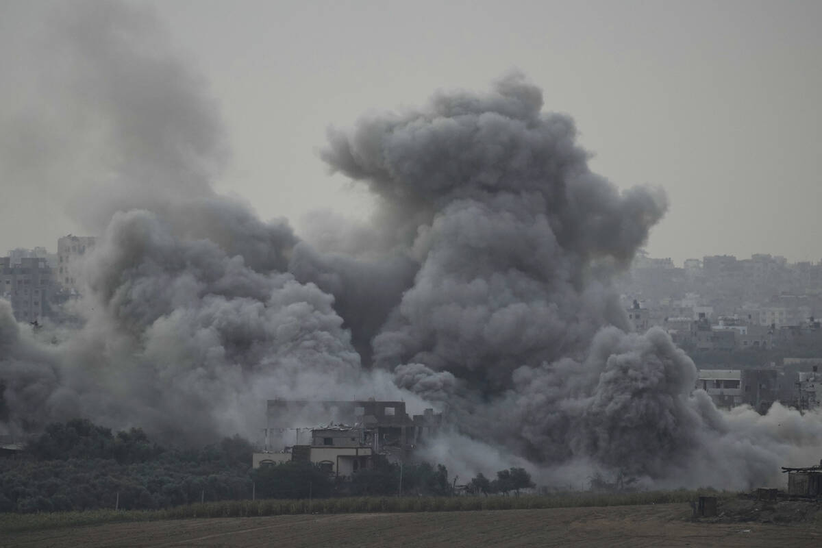 Smoke rises following an Israeli airstrike in the Gaza Strip, as seen from southern Israel, Sun ...